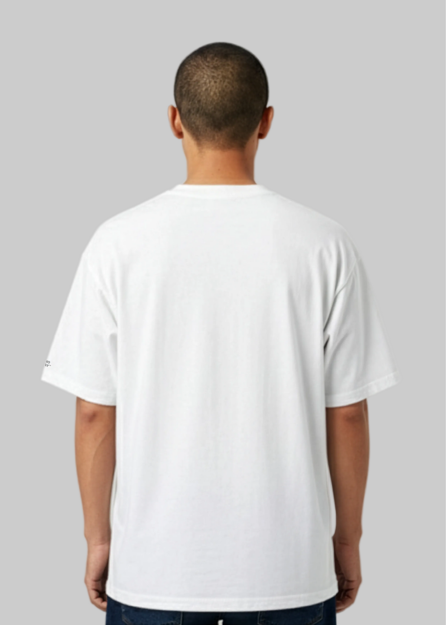Model wearing a Studio Viekay white t-shirt against a gray background