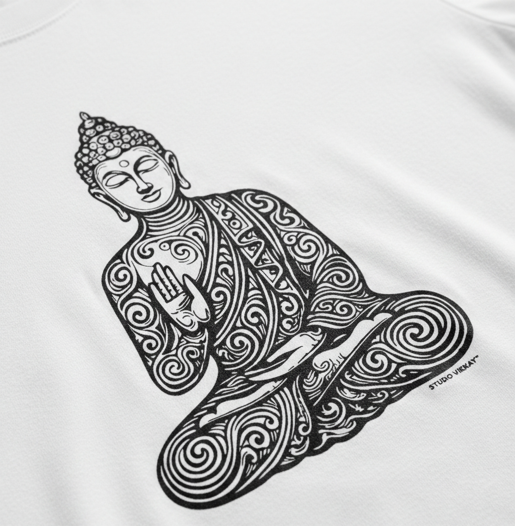 Close-up of a black and white intricate Buddha design on a white t-shirt