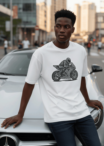 Model wearing Studio Viekay Motorcycle Engraved Art Box Tee while leaning against a white car in an urban street setting