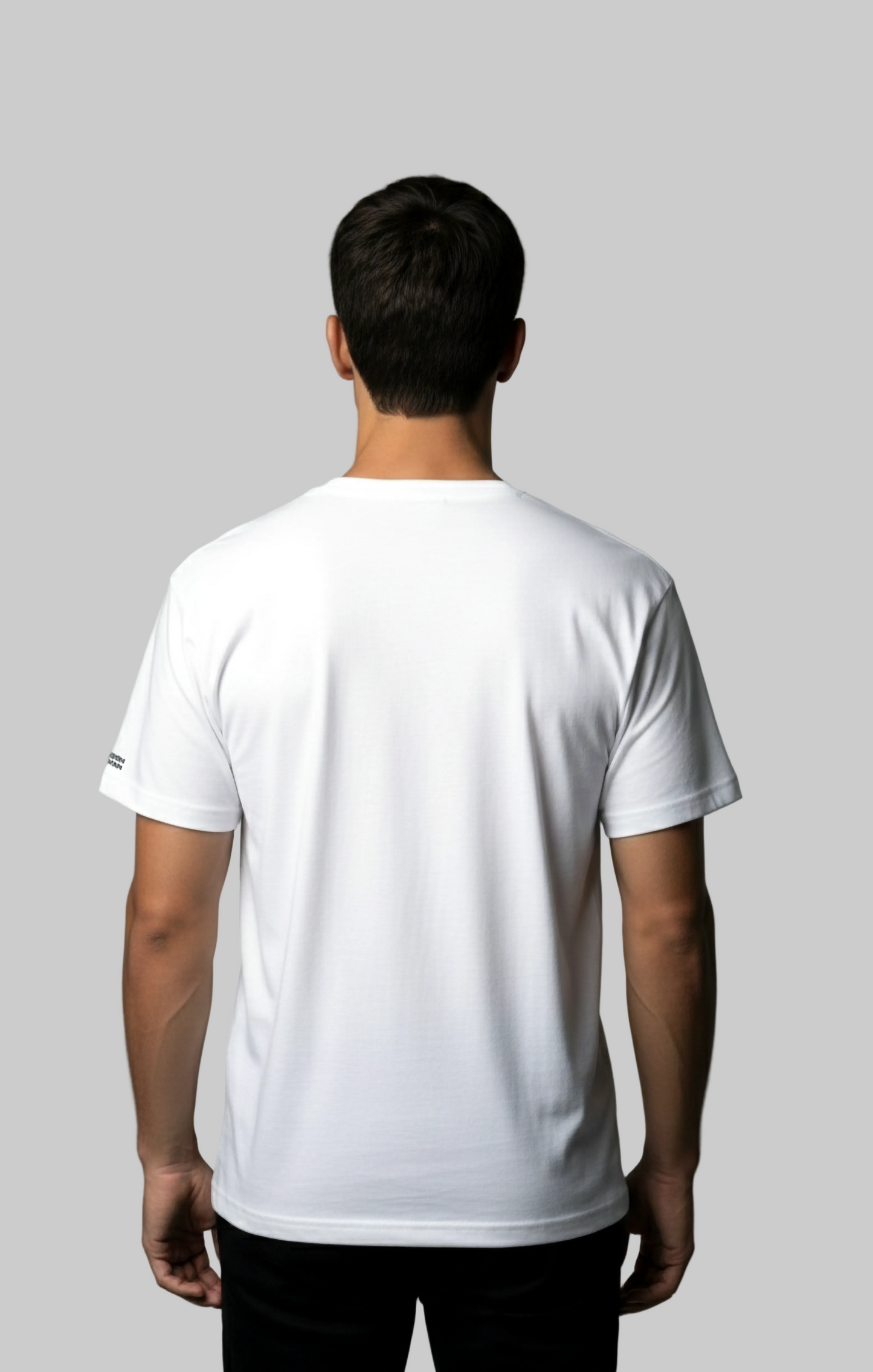 Back view of a male model wearing a white t-shirt against a gray background