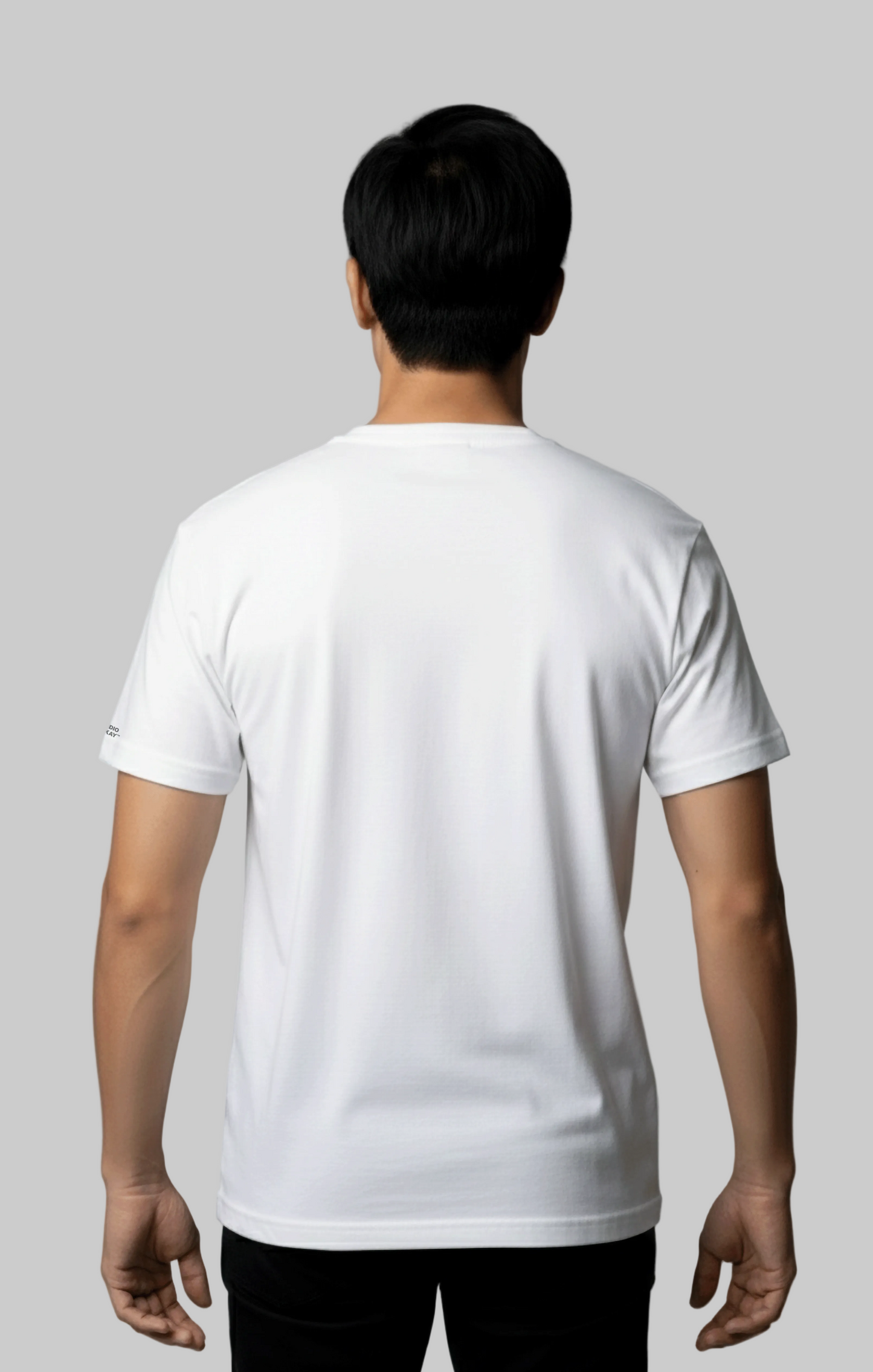 The back view of a male model wearing a plain white t-shirt against a gray background