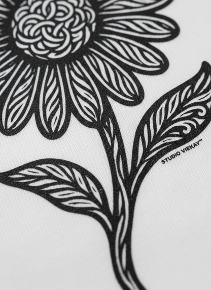 Close up of a black and white floral design with 'Studio Vieyra' branding on a white background
