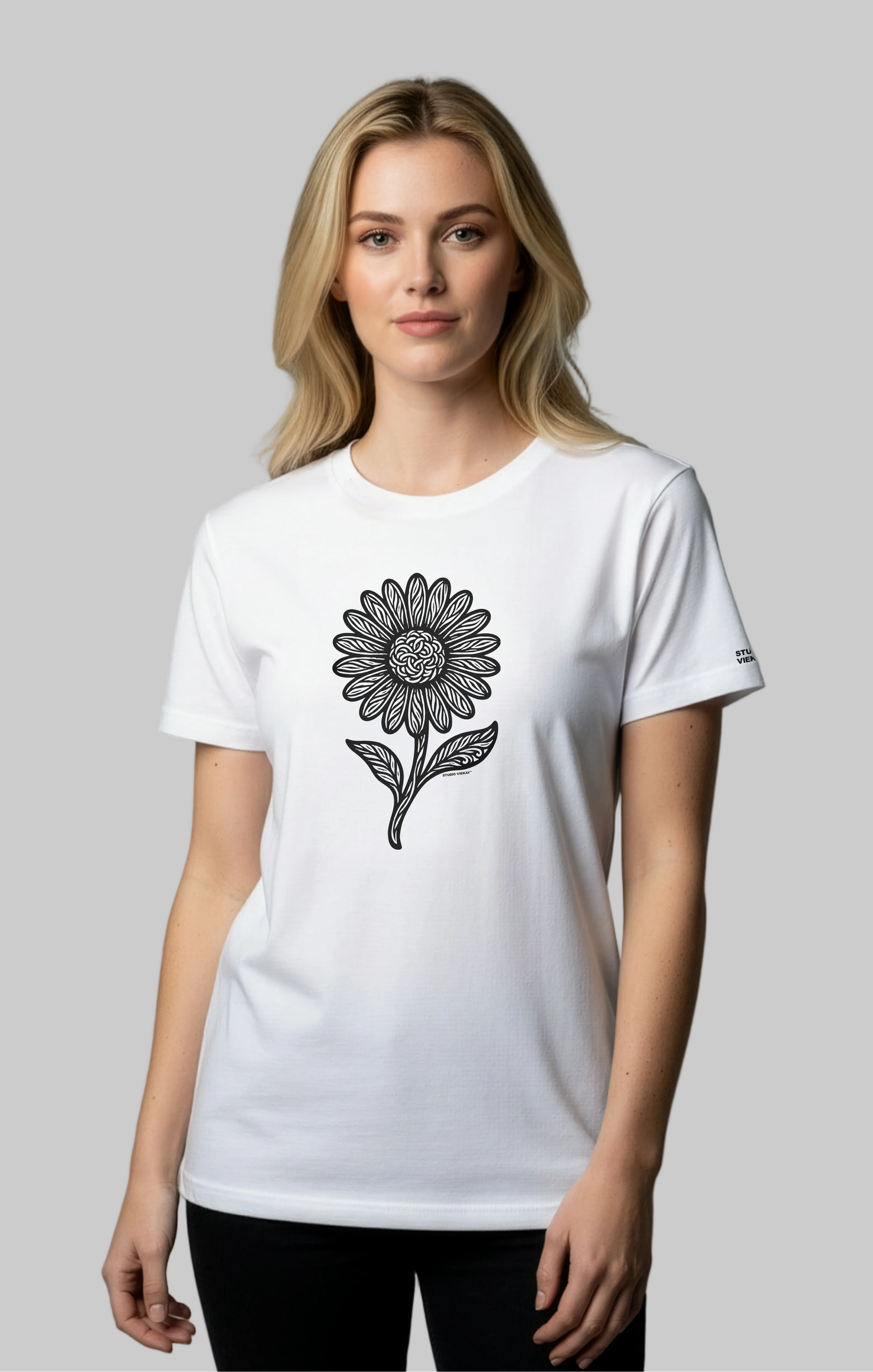 Model wearing a white Studio Viekay t-shirt with a black flower design on a gray background