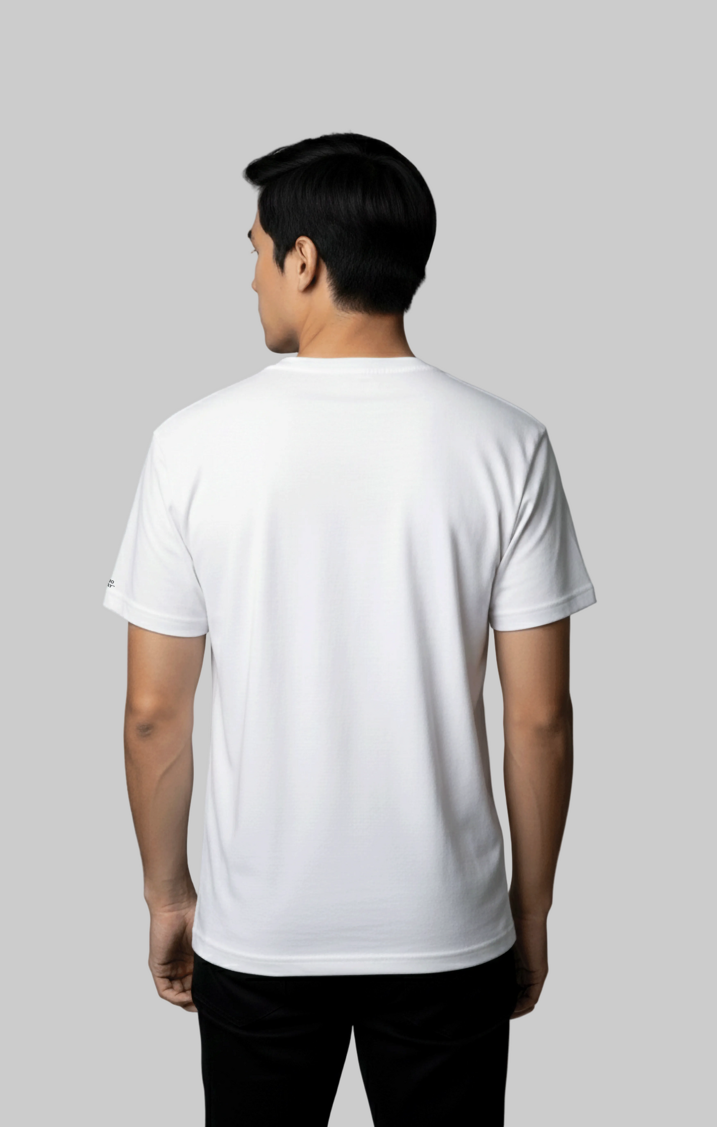 Back view of male model wearing a plain white t-shirt against a gray background