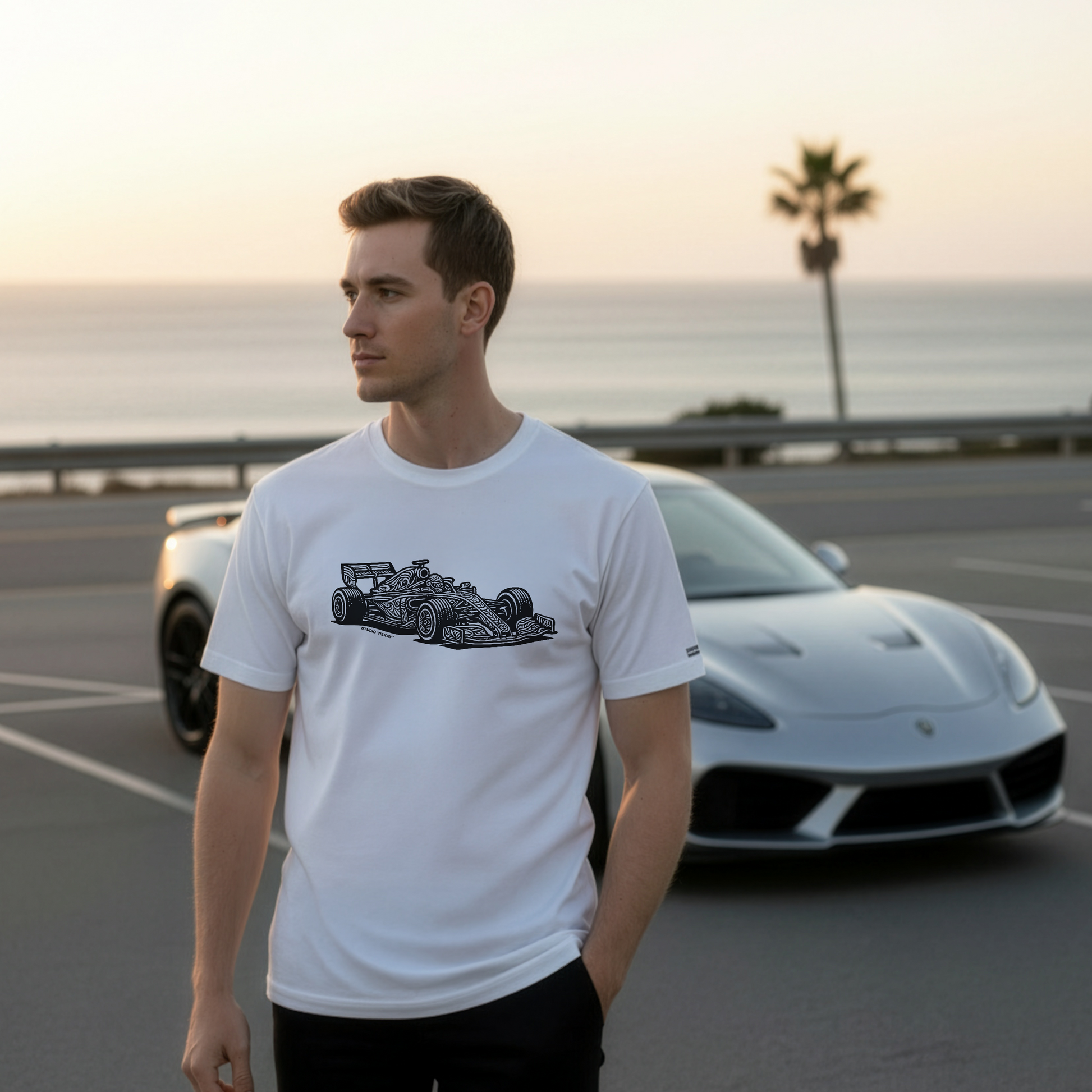 Model wearing a white Studio Viekay t-shirt with a graphic design of a Formula One car.