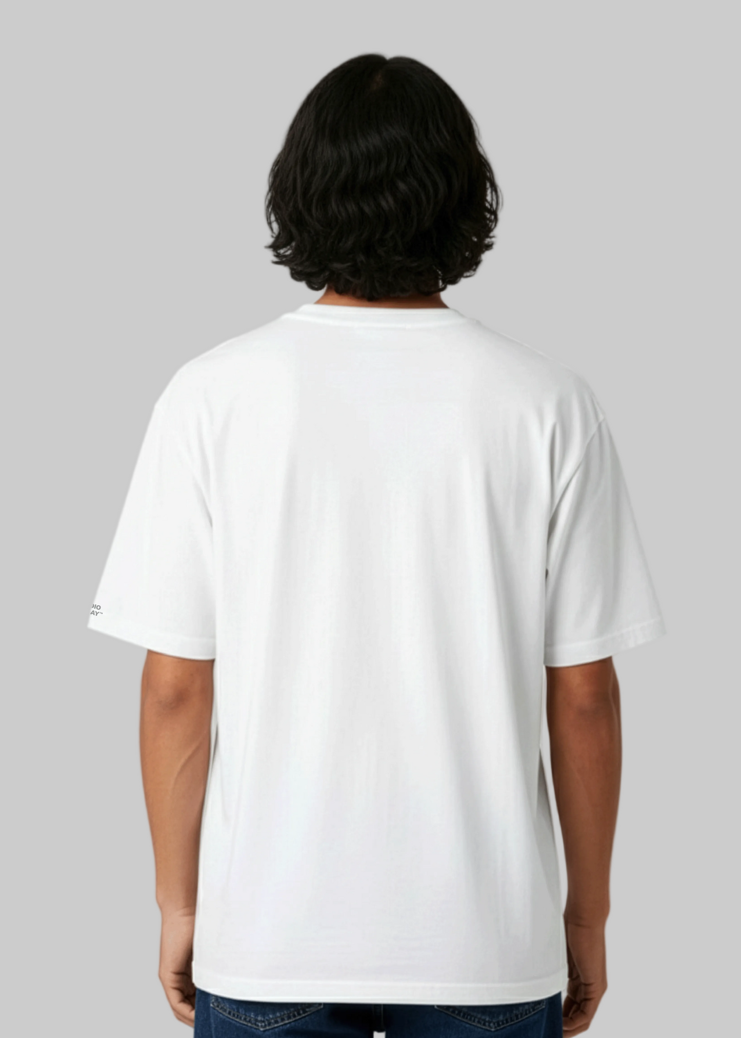 Back view of a model wearing a Studio Viekay tee against a gray background.