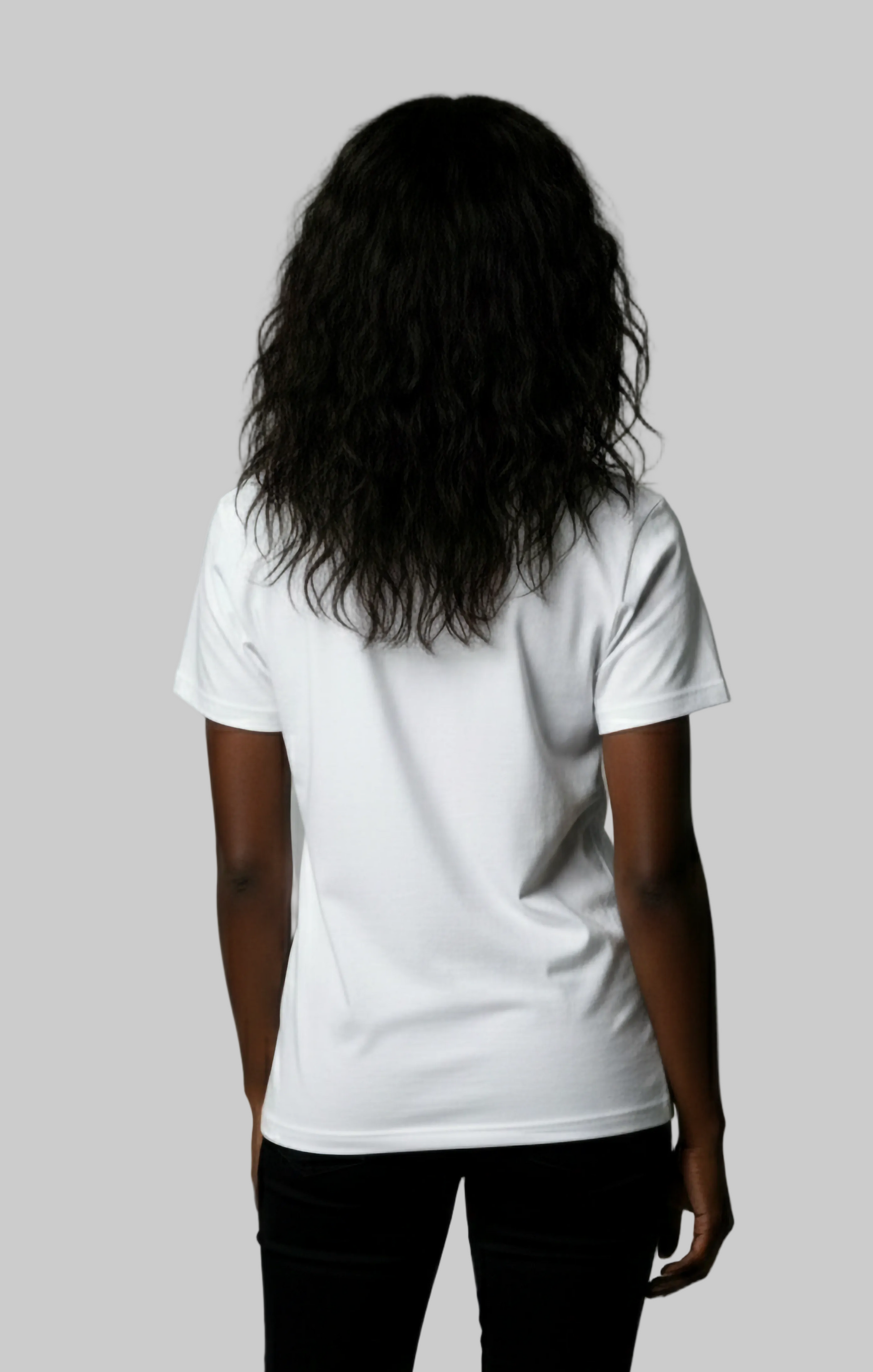 Back view of a model wearing a plain white t-shirt against a gray background