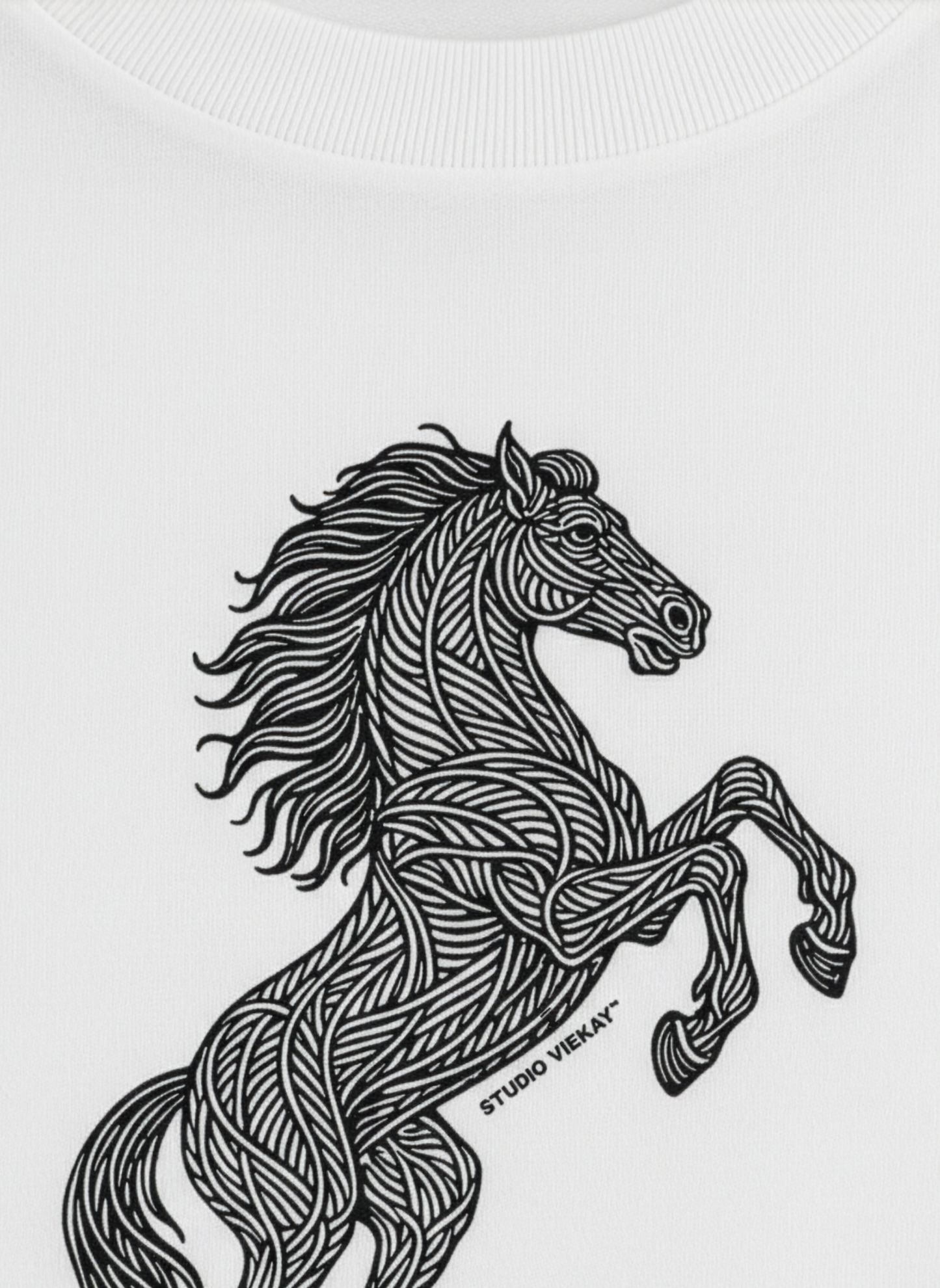 Detail of a Studio Viekay design of a graphic horse on a white tee