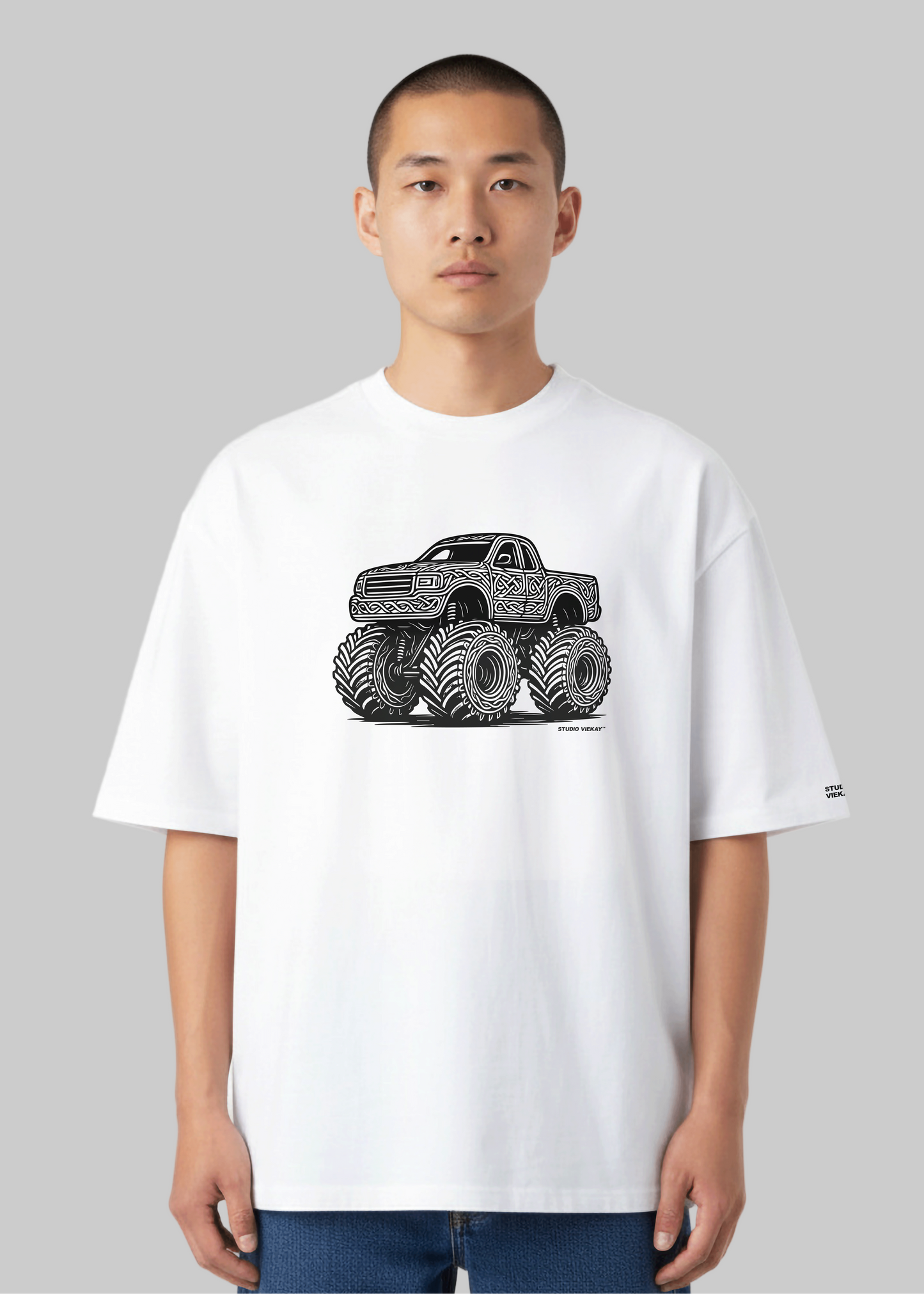 Model wearing the Studio Viekay Monster Truck Engraved Art Box Tee in an alternate front angle showing the detailed black and white monster truck artwork