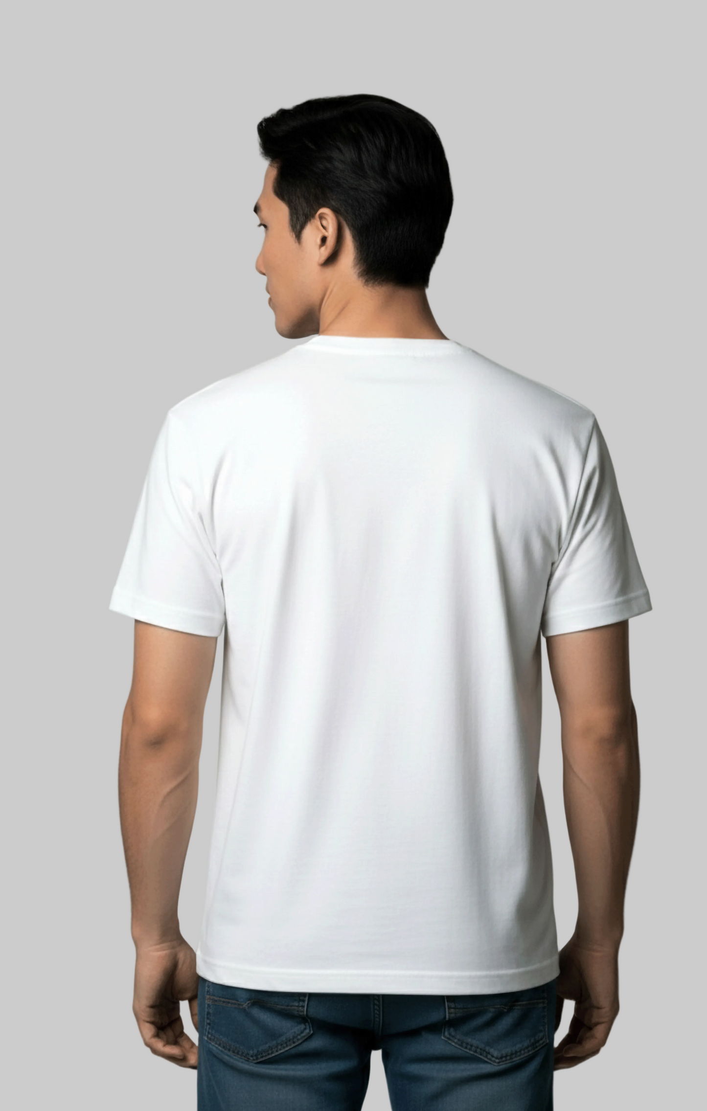 Back view of a man wearing a plain white t-shirt against a gray background
