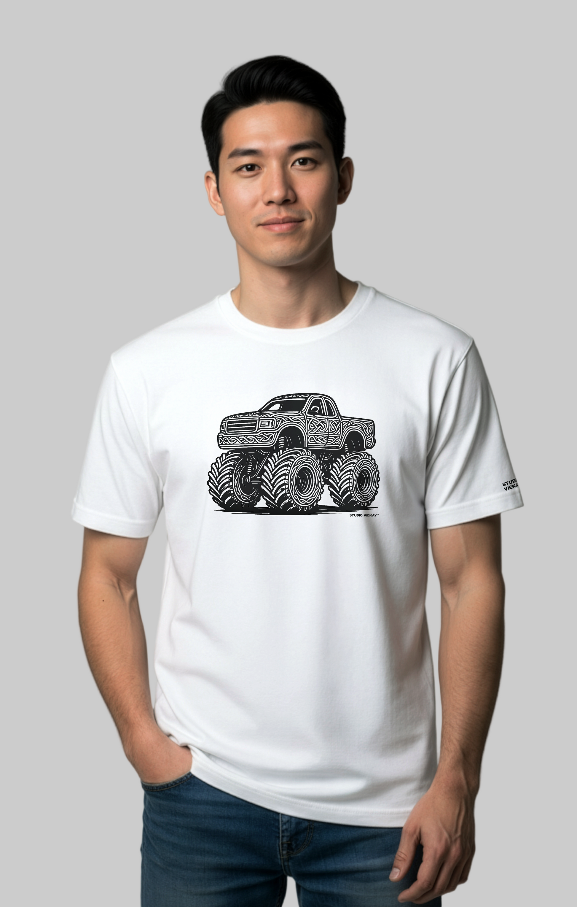 Model wearing the Studio Viekay Monster Truck Engraved Art Tee with bold carved monster truck artwork in clean black and white linework
