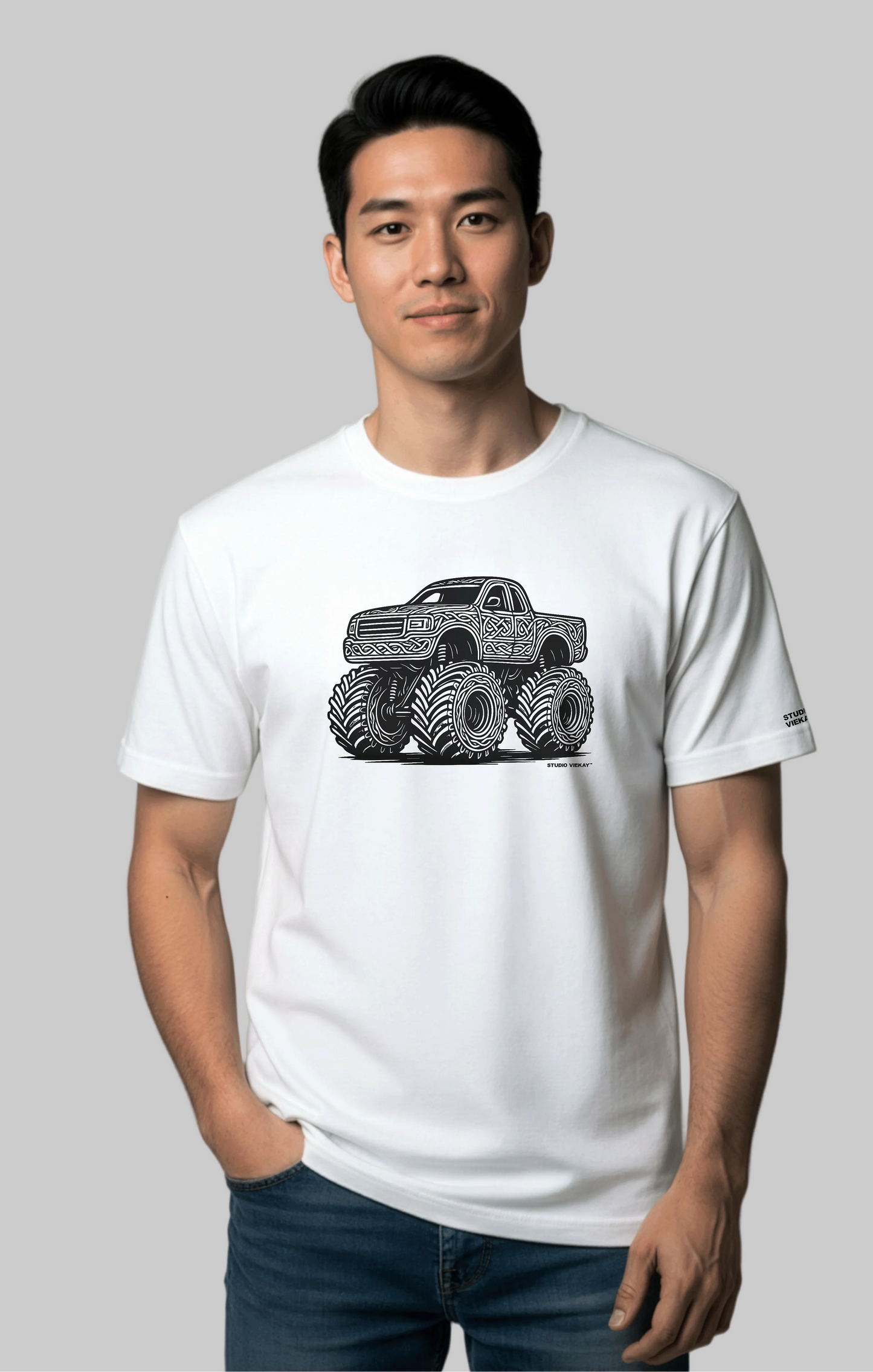Model wearing the Studio Viekay Monster Truck Engraved Art Tee with bold carved monster truck artwork in clean black and white linework
