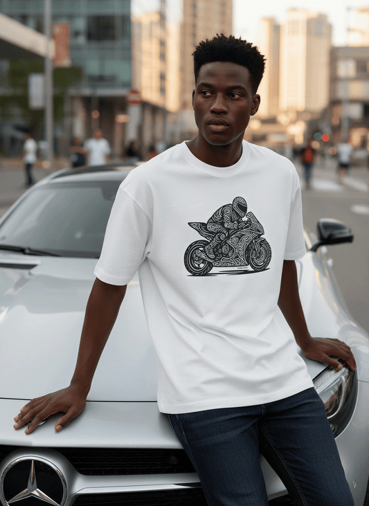 Model wearing Studio Viekay Motorcycle Engraved Art Box Tee while leaning against a white car in an urban street setting