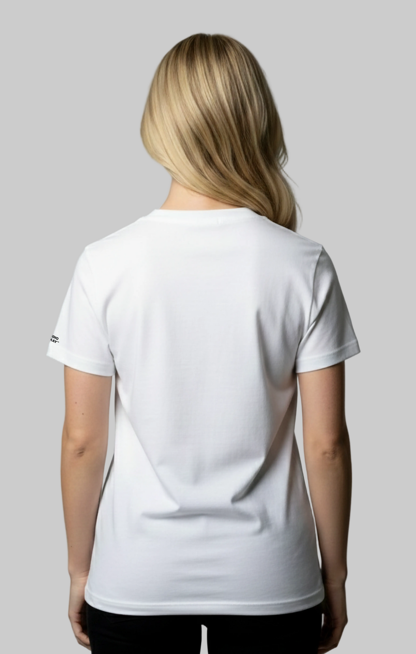Back view of a female model wearing a white t-shirt on a gray background
