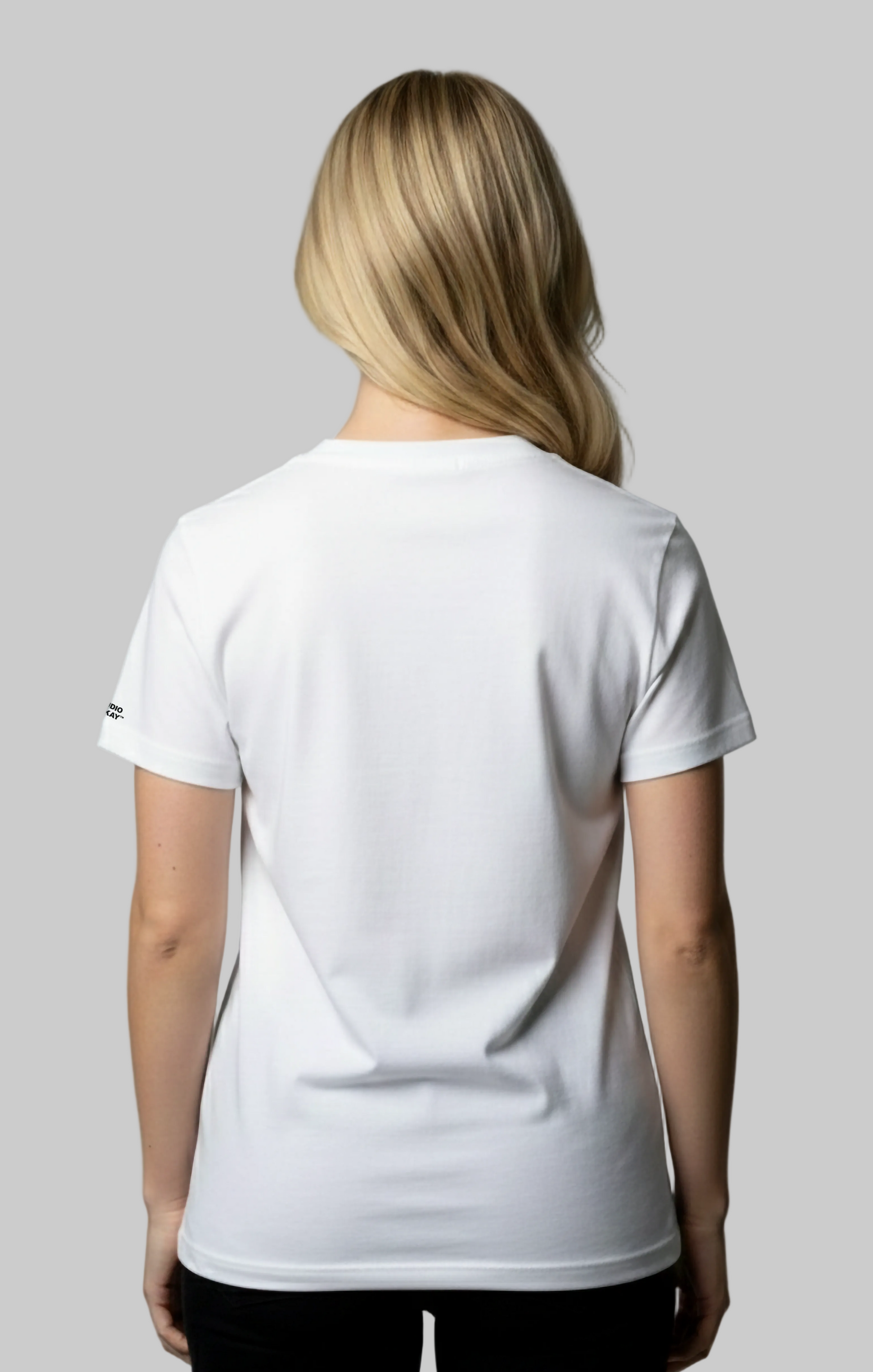 Back view of a female model wearing a white t-shirt on a gray background