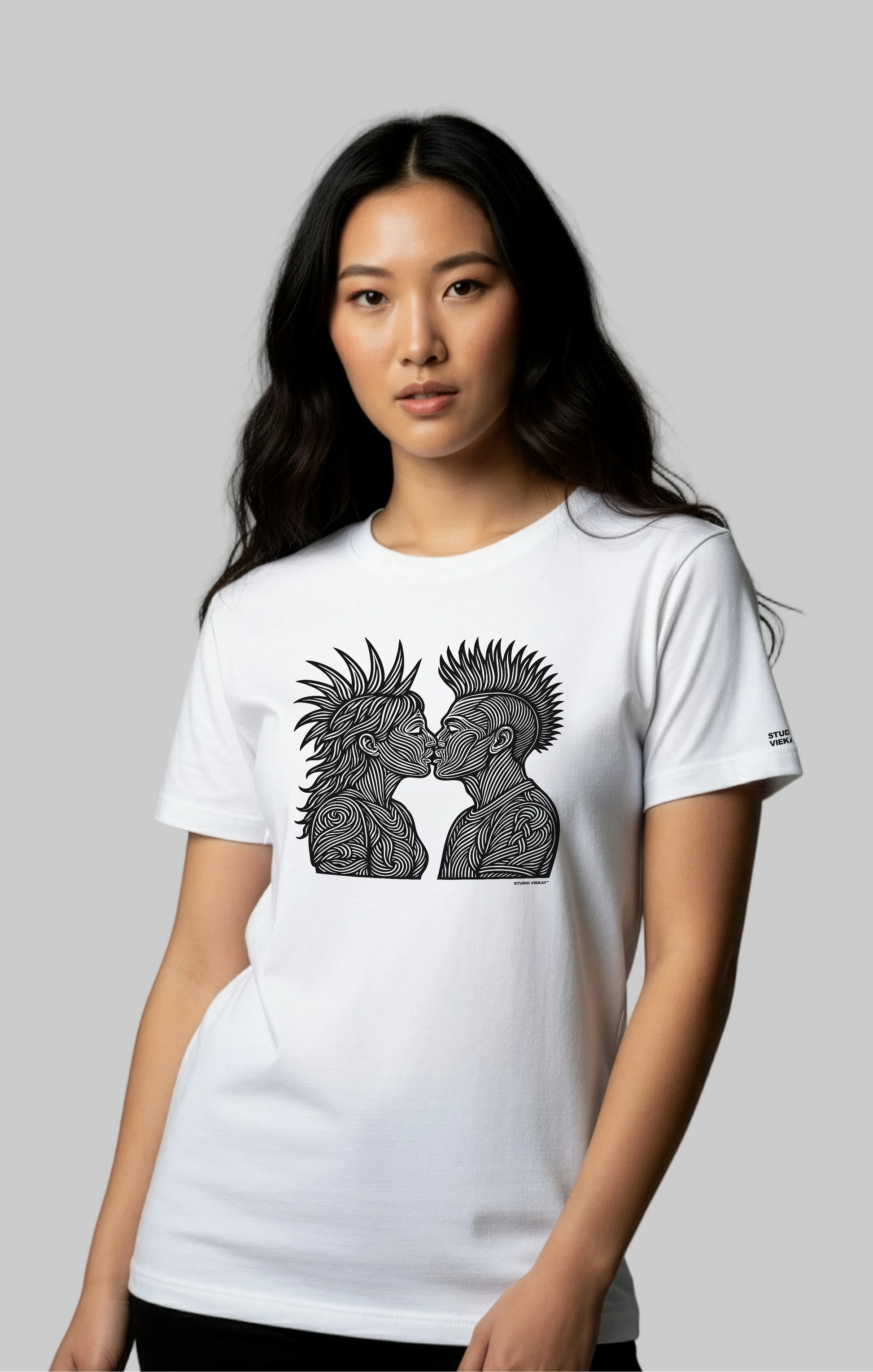 Model wearing a white Studio Viekay t-shirt with a graphic design on a gray background