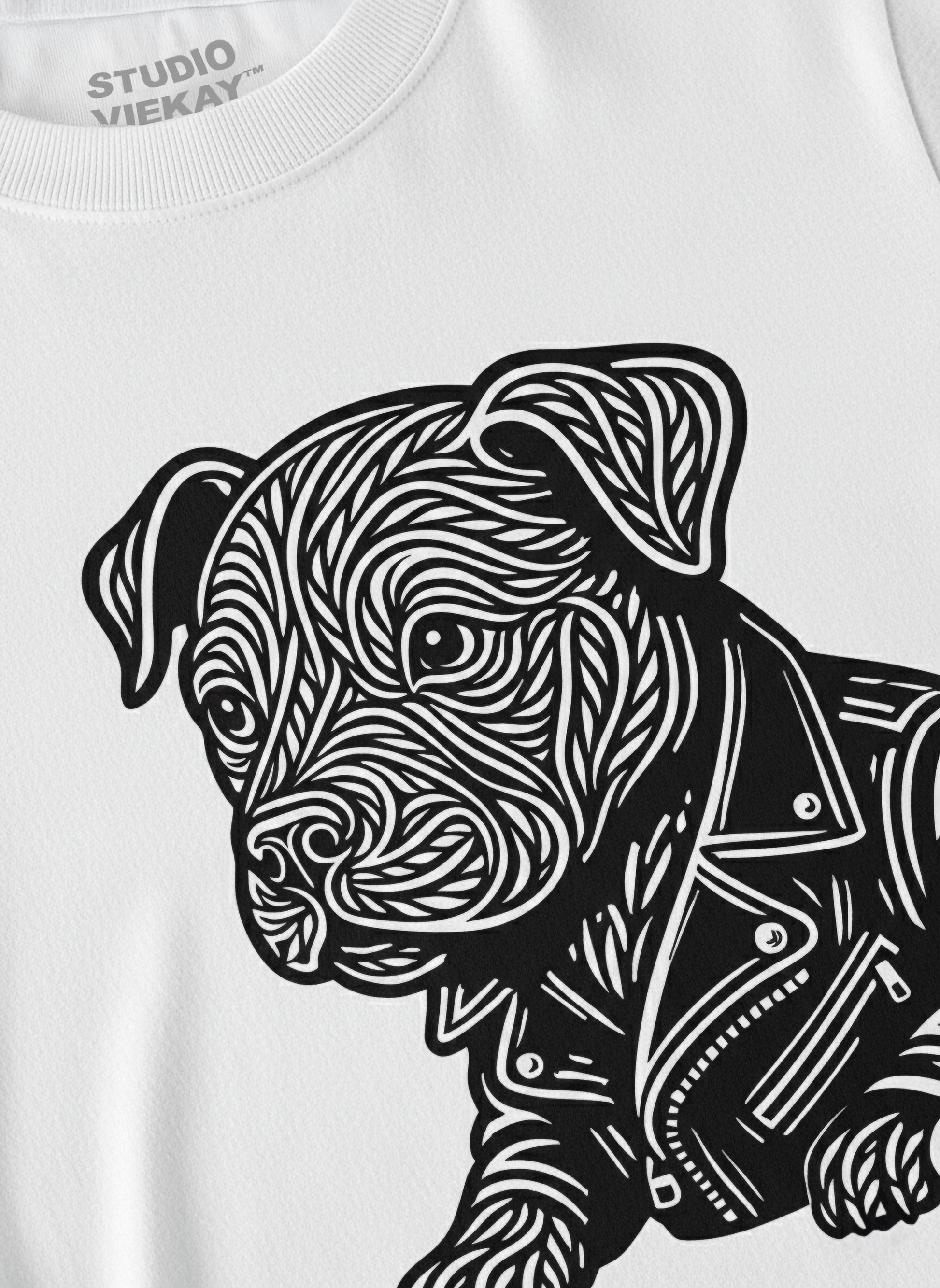 Close-up of a white t-shirt with a black and white graphic of a dog wearing a jacket.