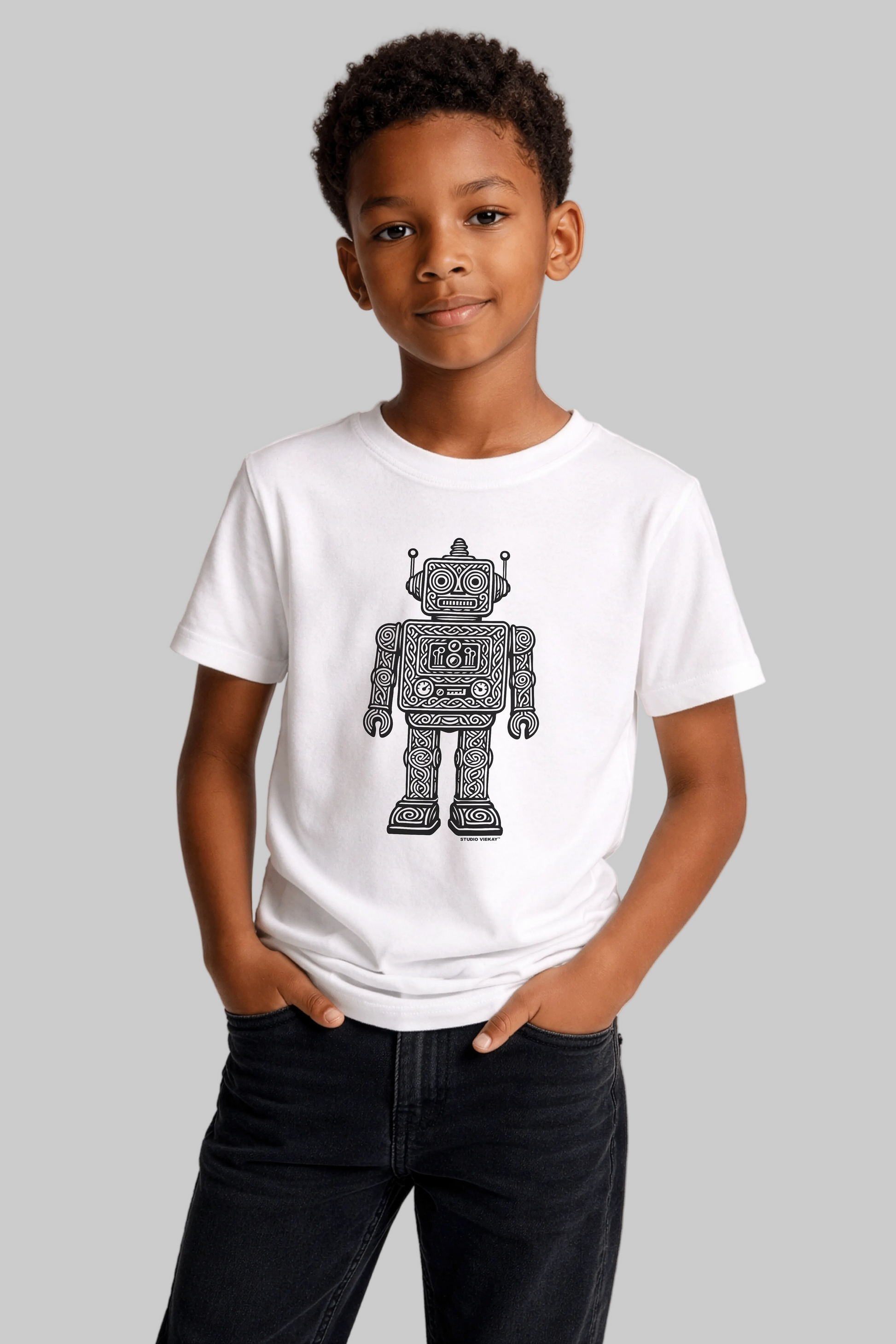 Young model wearing a white t-shirt with a robot graphic on a plain background