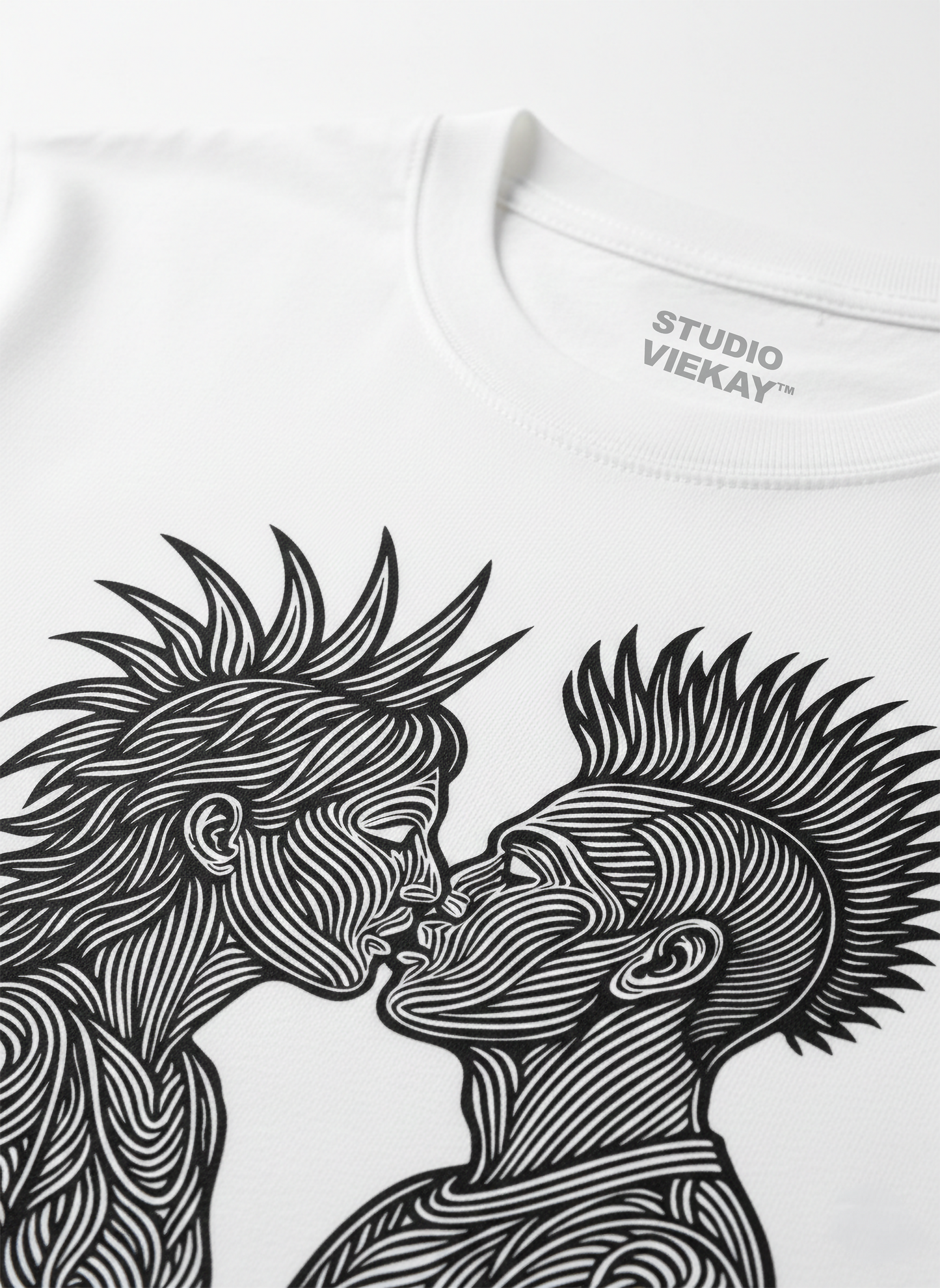 Close-up of a graphic design of two faces kissing, featuring 'Studio Viekay' branding.
