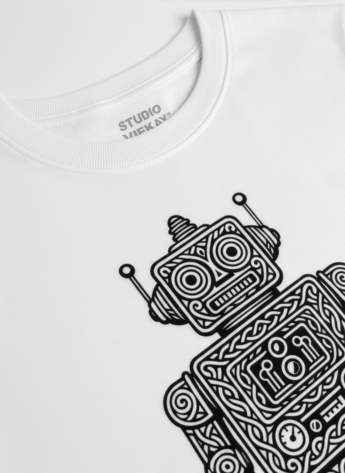 Close-up of a white t-shirt with a black retro robot graphic.