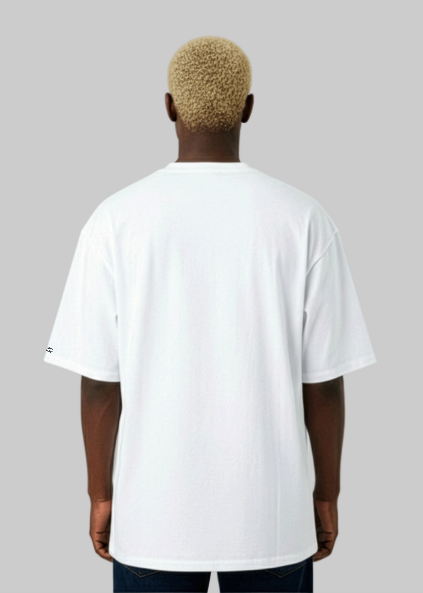 Back view of a Model wearing a Studio Viekay white t-shirt on a plain background