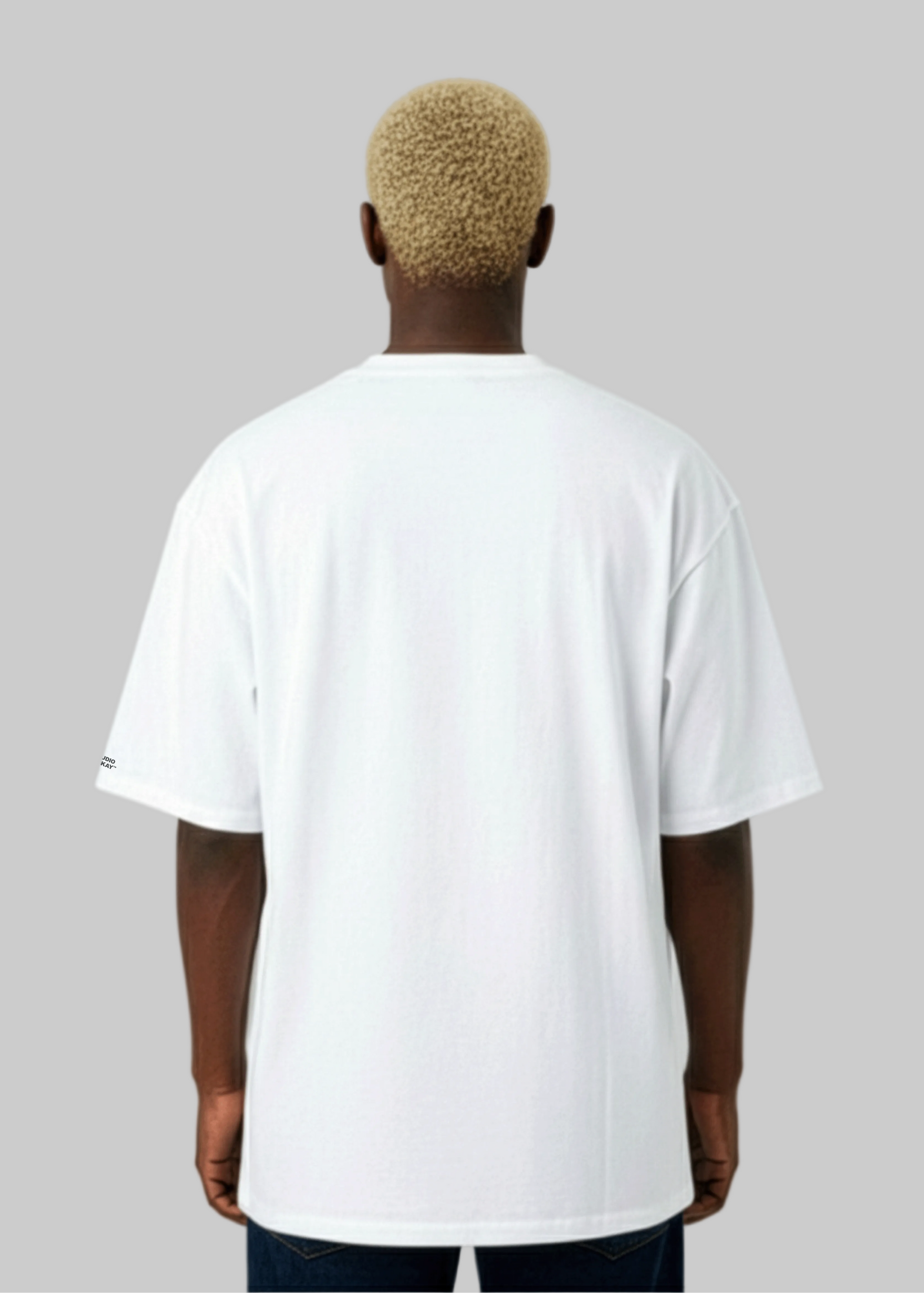 Back view of a Model wearing a Studio Viekay white t-shirt on a plain background