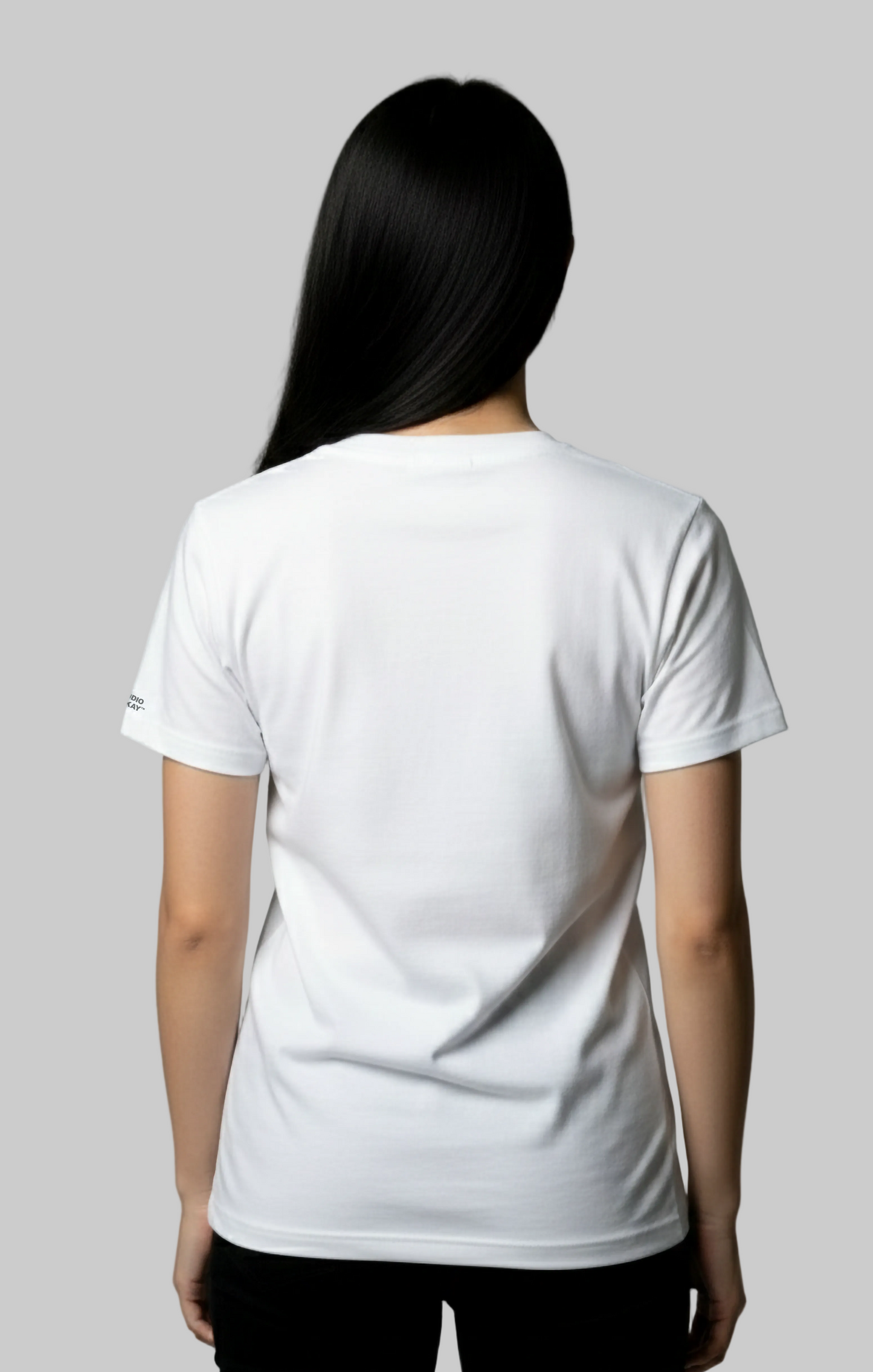 Back view of a model wearing a plain white t-shirt against a gray background