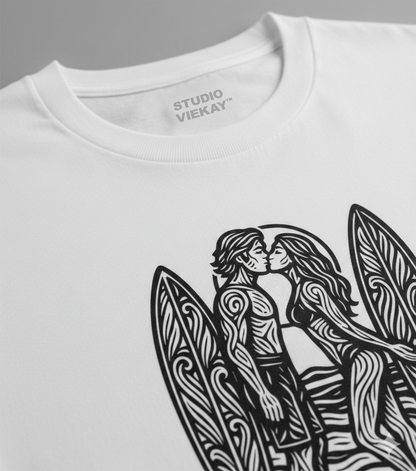 Close-up of a Studio Viekay white t-shirt with black graphic design of two people kissing next to surfboards.